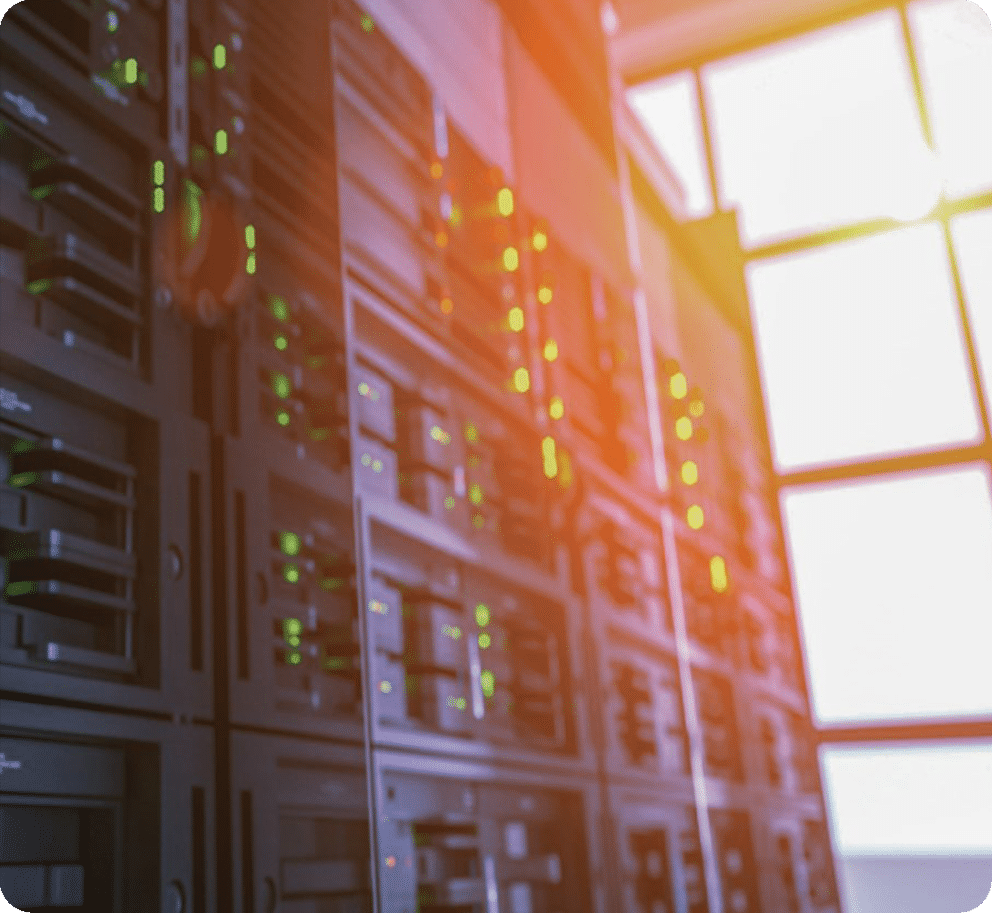 Server room with flashing lights and blurred background.